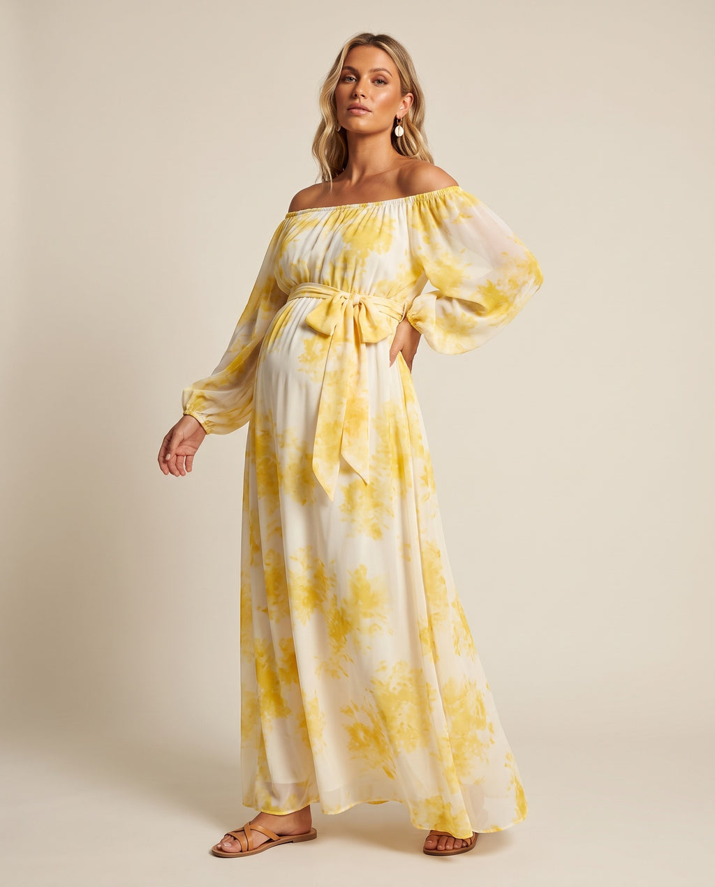 Yellow floral chiffon off-shoulder maternity maxi dress with balloon sleeves and sash, designed for beach photoshoots.