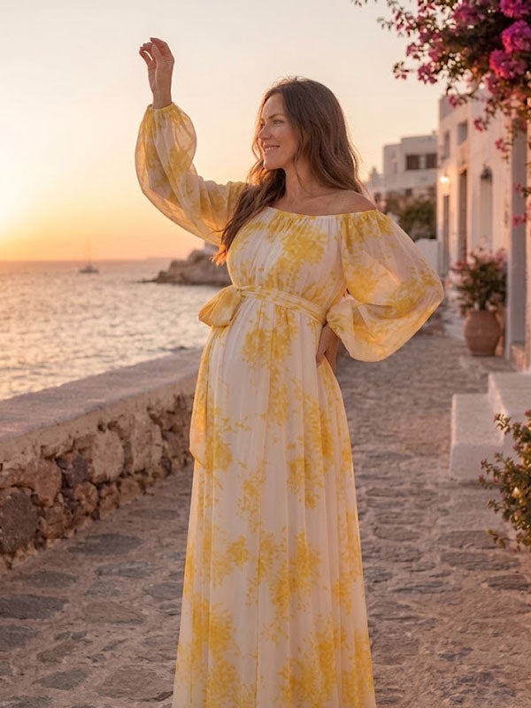 Yellow watercolor print chiffon maternity maxi dress with off-shoulder neckline and tie waist, designed for beach photoshoot.