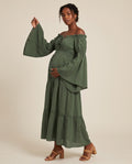 Olive green off-shoulder boho maternity maxi dress with bell sleeves and tiered skirt, designed for maternity photoshoots.