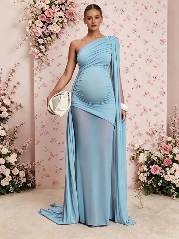 Sky blue ruched mesh maternity maxi dress with one-shoulder cape panel and sheer train, designed for baby shower.