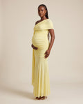 Yellow mesh maternity maxi dress with one-shoulder draped panel and ruched bodice, designed for maternity photoshoots.