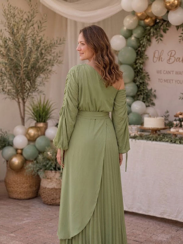 Back view of sage green pleated maternity maxi dress with one-shoulder neckline, ruched drawstring sleeves and tie waist, designed for baby shower.