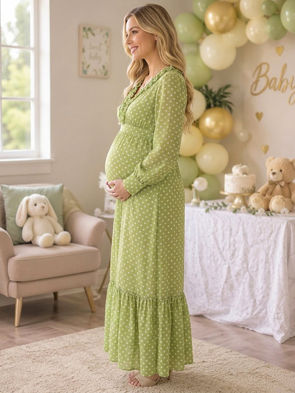Side view of green polka dot maternity maxi dress with ruffled V-neck, long sleeves and tiered hem, designed for baby shower.