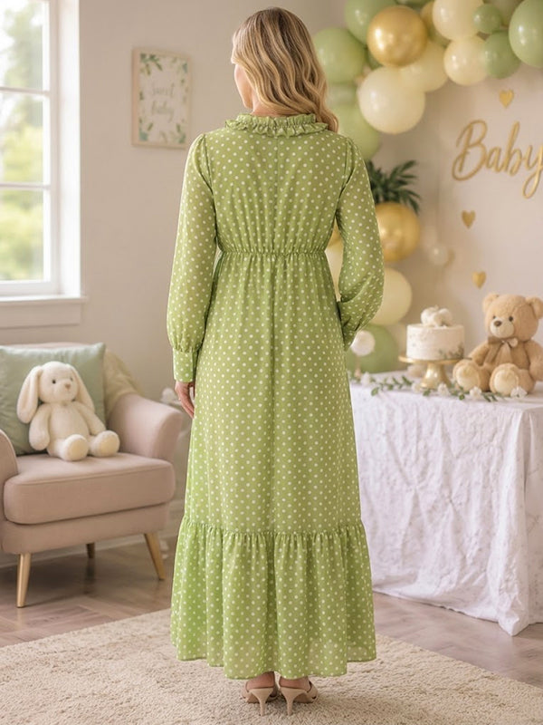 Back view of green polka dot maternity maxi dress with ruffled V-neck, long sleeves and tiered hem, designed for baby shower.