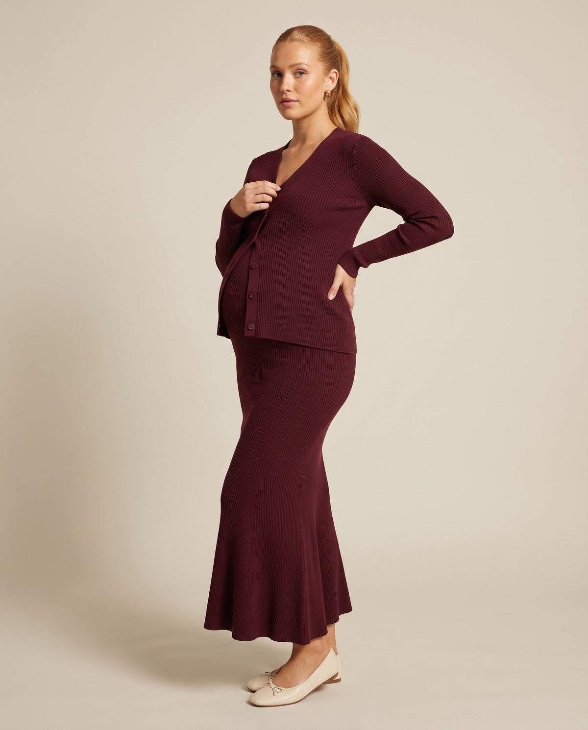 Burgundy rib knit maternity two-piece set with button cardigan and fishtail skirt, designed for photoshoots.