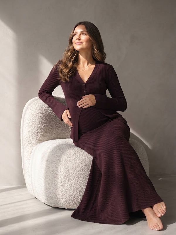 Burgundy rib knit maternity two-piece set with button cardigan and fitted maxi skirt, designed for maternity photoshoot.