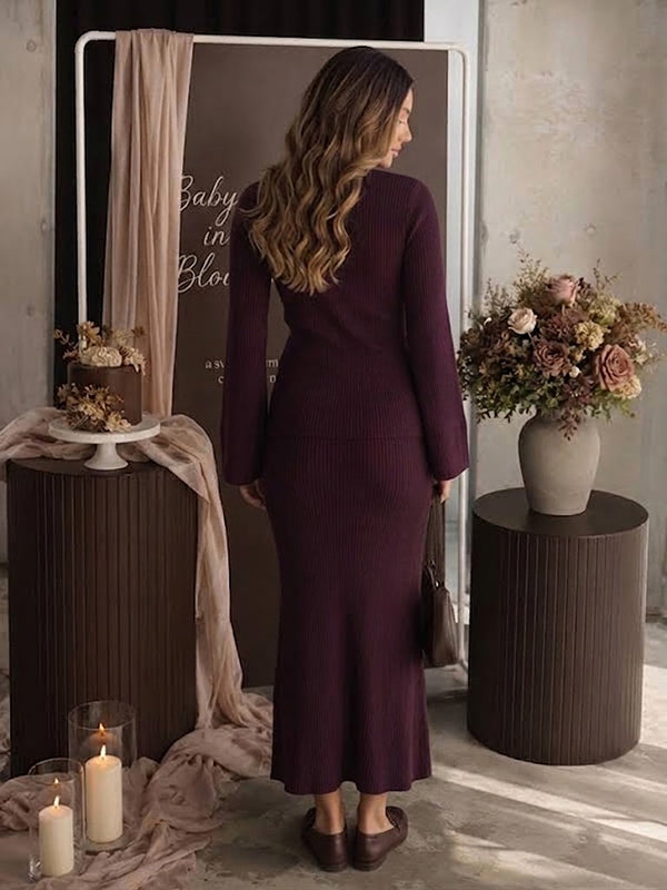 Back view of burgundy rib knit maternity two-piece set with button cardigan and fitted maxi skirt, designed for maternity photoshoot.