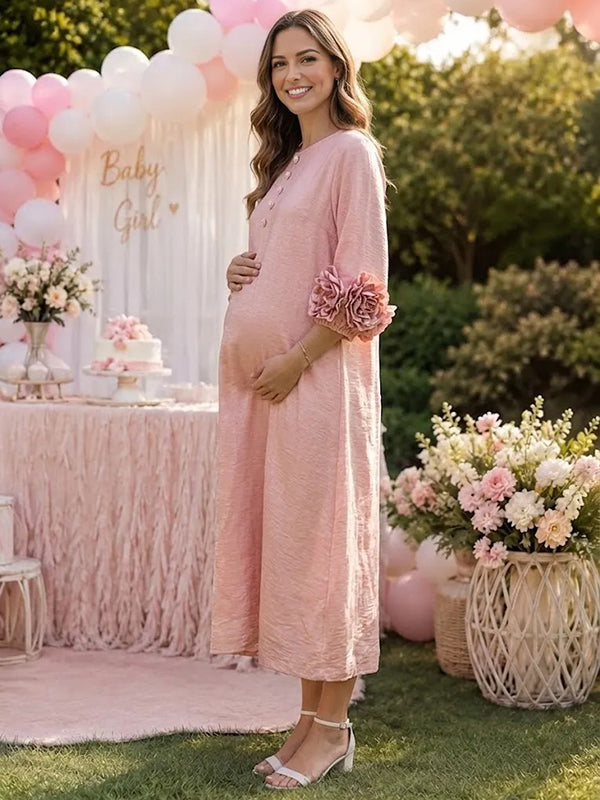 Side view of pink textured maternity midi dress with button placket and 3D rosette sleeve cuffs, designed for baby shower.
