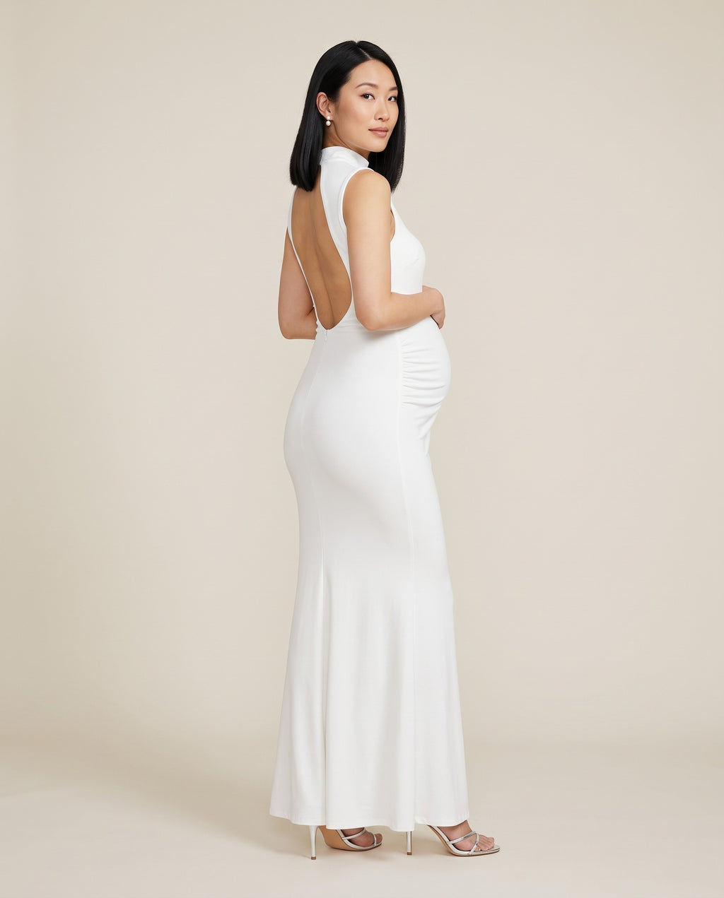 White jersey maternity maxi dress with side ruching and open back, designed for baby showers and photoshoots.