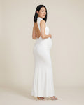 White jersey maternity maxi dress with side ruching and open back, designed for baby showers and photoshoots.