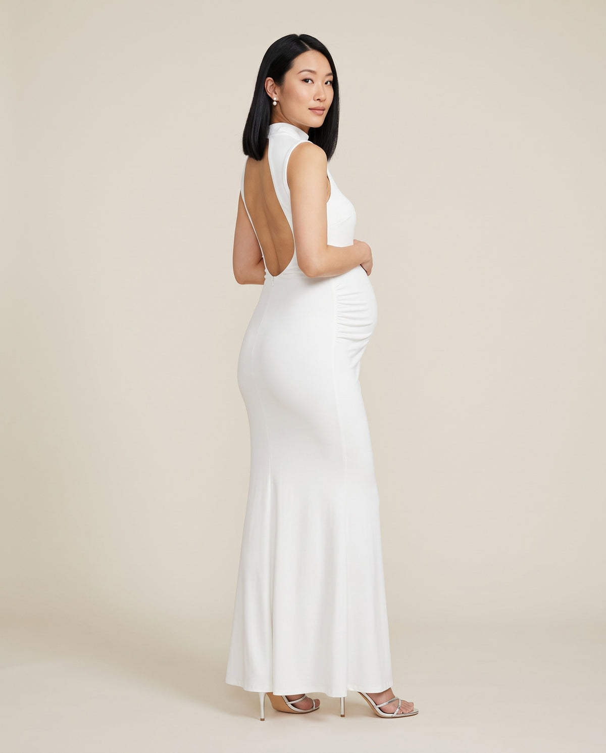 White jersey maternity maxi dress with side ruching and open back, designed for baby showers and photoshoots.