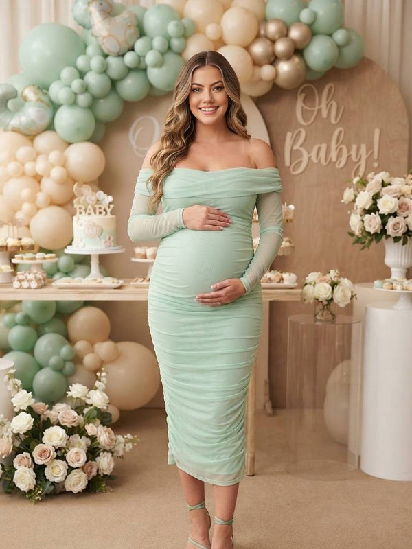Mint green ruched mesh maternity midi dress with off-shoulder neckline and sheer long sleeves, designed for baby shower.