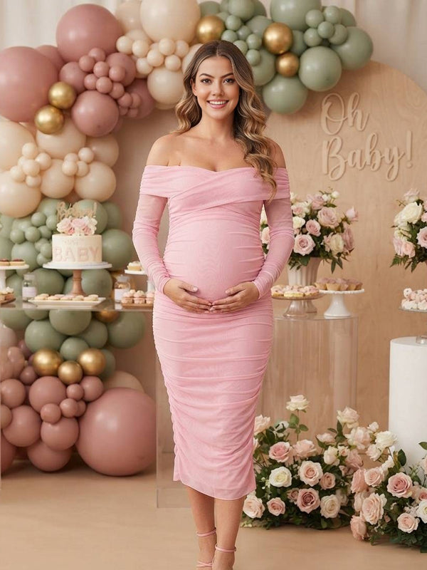 Pink ruched mesh maternity midi dress with off-shoulder neckline and sheer long sleeves, designed for baby shower.