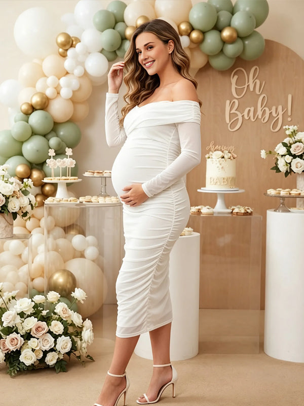 Side view of white ruched mesh maternity midi dress with off-shoulder neckline and sheer long sleeves, designed for baby shower.