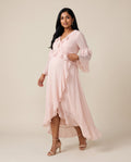 Pink chiffon maternity wrap dress with ruffle trim and high-low hem, designed for baby showers.
