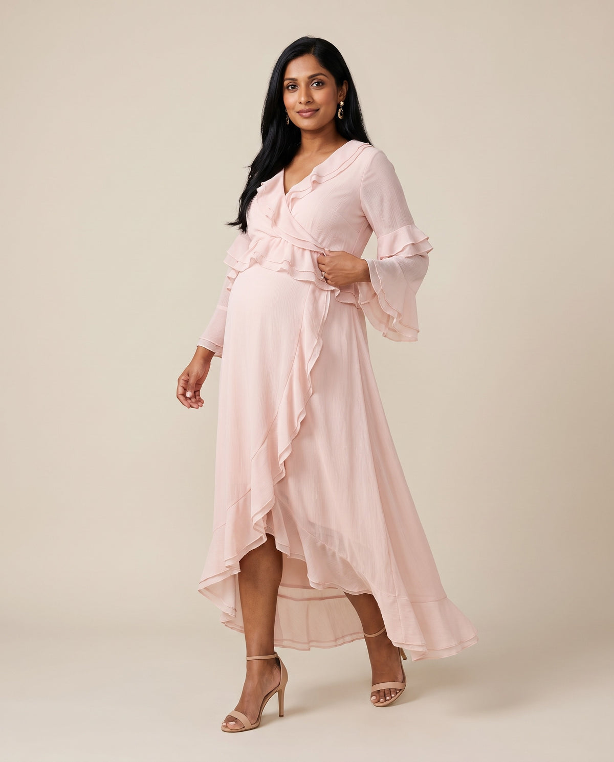 Pink chiffon maternity wrap dress with ruffle trim and high-low hem, designed for baby showers.