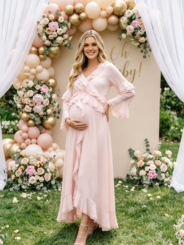 Light pink chiffon maternity maxi dress with ruffled V-neck, tiered ruffle bell sleeves and high-low ruffle hem, designed for baby shower.