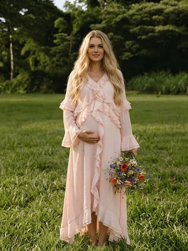Light pink chiffon maternity maxi dress with ruffled V-neck, tiered ruffle bell sleeves and high-low ruffle hem, designed for baby shower.