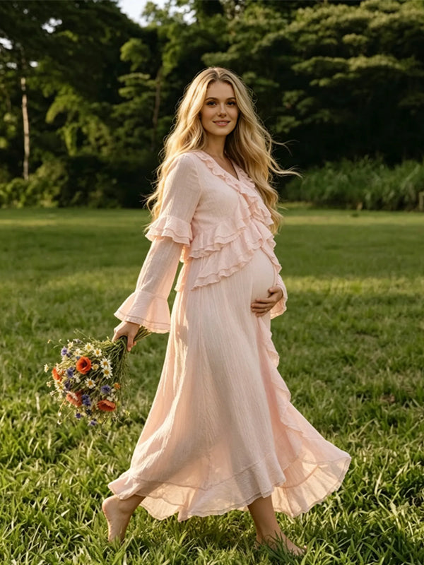 Side view of light pink chiffon maternity maxi dress with ruffled V-neck, tiered ruffle bell sleeves and high-low ruffle hem, designed for baby shower.