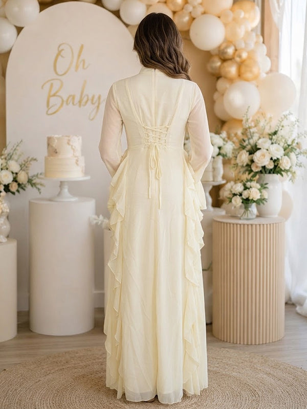 Back view of pale yellow chiffon maternity maxi dress with mock neck, bell sleeves and side ruffles, designed for baby shower.