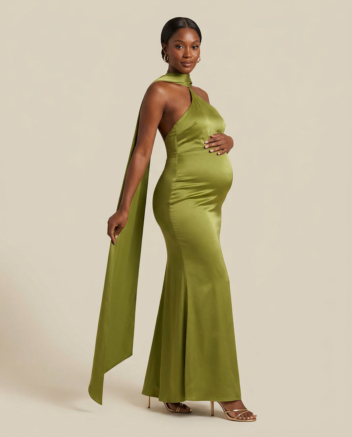 Green satin maternity maxi dress with halter neckline and matching scarf, designed for maternity photoshoots and formal events.