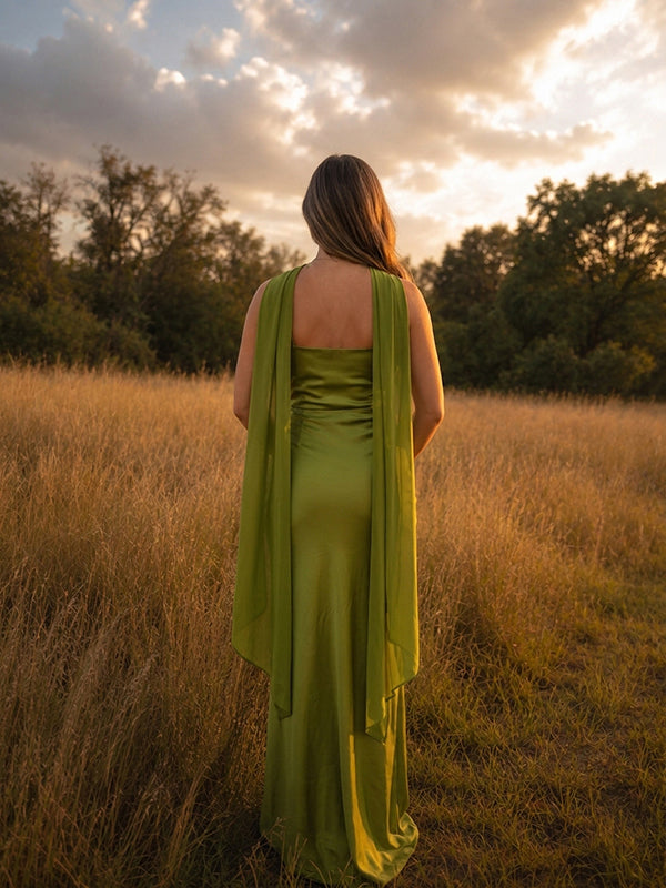 Back view of chartreuse green satin maternity maxi dress with halter neck and long trailing scarf, designed for maternity photoshoot.