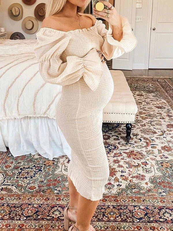 Side view of ivory smocked maternity midi dress with off-shoulder neckline and puff sleeves, designed for baby shower.