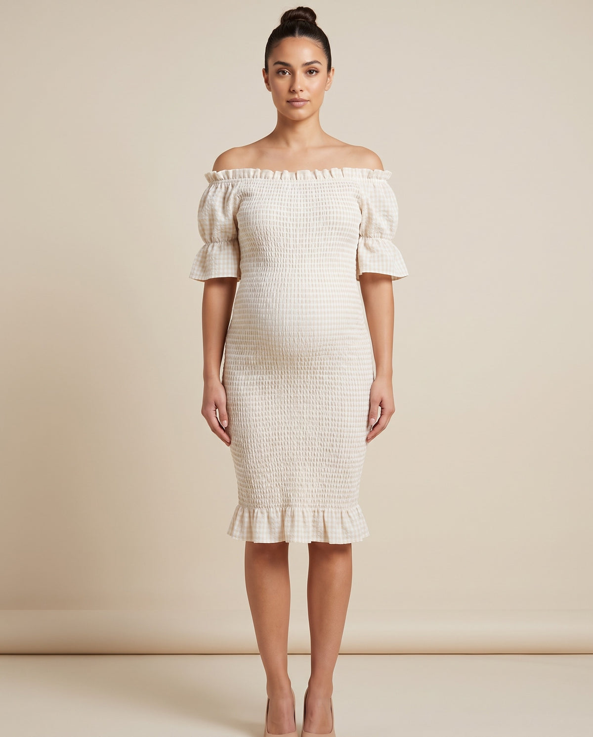 Ivory smocked maternity midi dress with short flutter sleeves and ruffle hem, designed for baby shower and everyday wear.