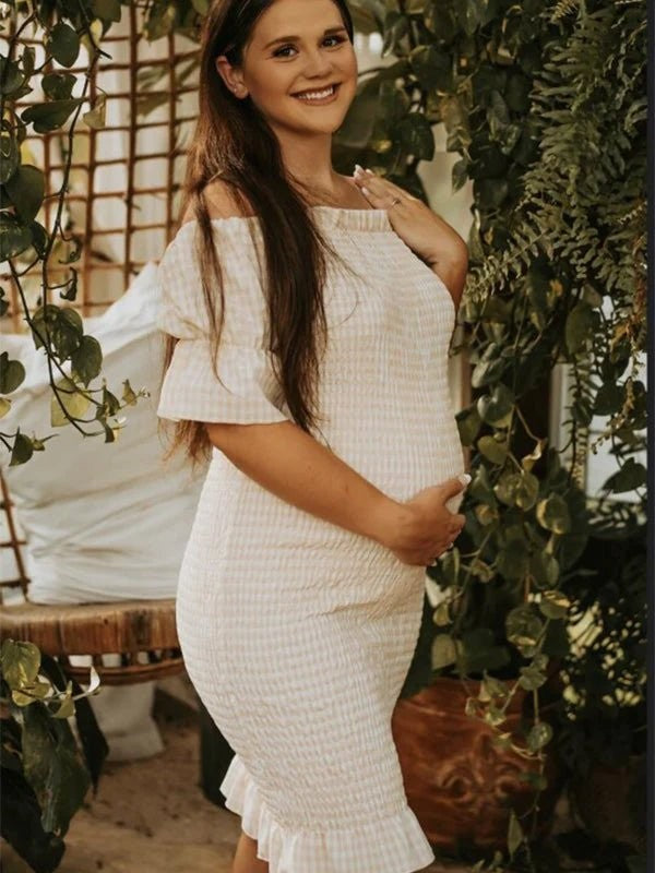 Ivory smocked maternity midi dress with off-shoulder neckline and short puff sleeves, designed for baby shower.