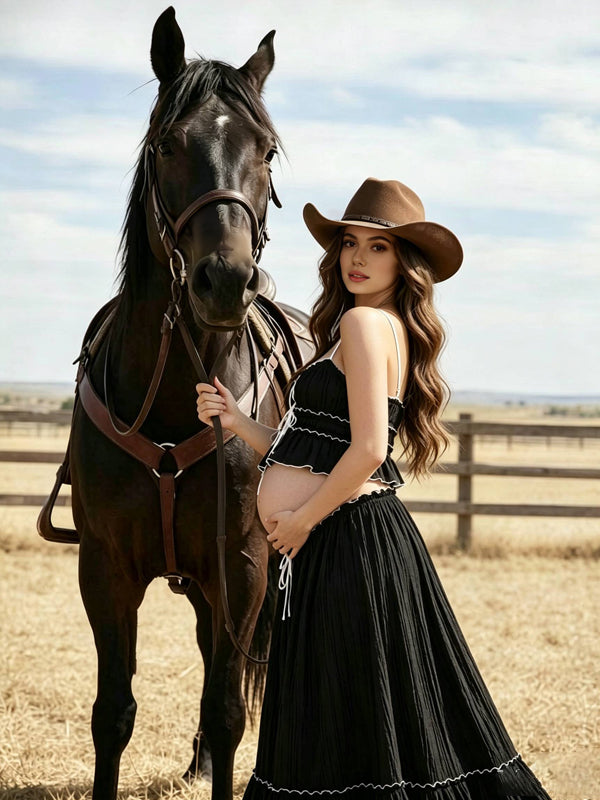 Black maternity two-piece set with smocked ruffle cami crop top and drawstring ruffle-hem maxi skirt, designed for maternity photoshoot.