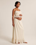Ivory crinkled cotton maternity two-piece set with ruffle cami top and tie-front maxi skirt, designed for baby shower and maternity photoshoots.