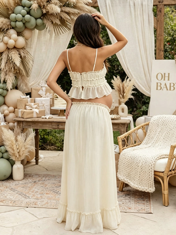 Back view of ivory maternity two-piece set with smocked ruffle cami crop top and drawstring ruffle-hem maxi skirt, designed for maternity photoshoot.