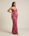 Red lace maternity maxi dress with strapless corset bodice and flowing skirt, designed for evening maternity photoshoots.