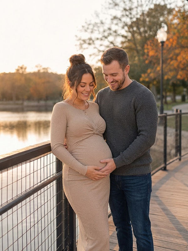 Beige knit maternity midi dress with twist front and long sleeves, designed for maternity photoshoot.