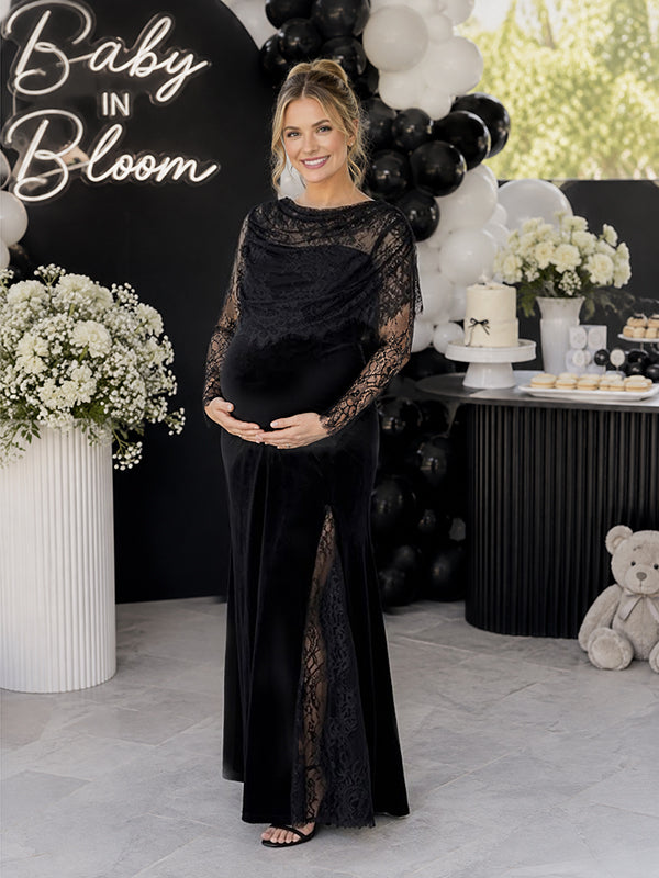 Black velvet maternity maxi dress with lace cape overlay and lace sleeves, designed for baby shower.